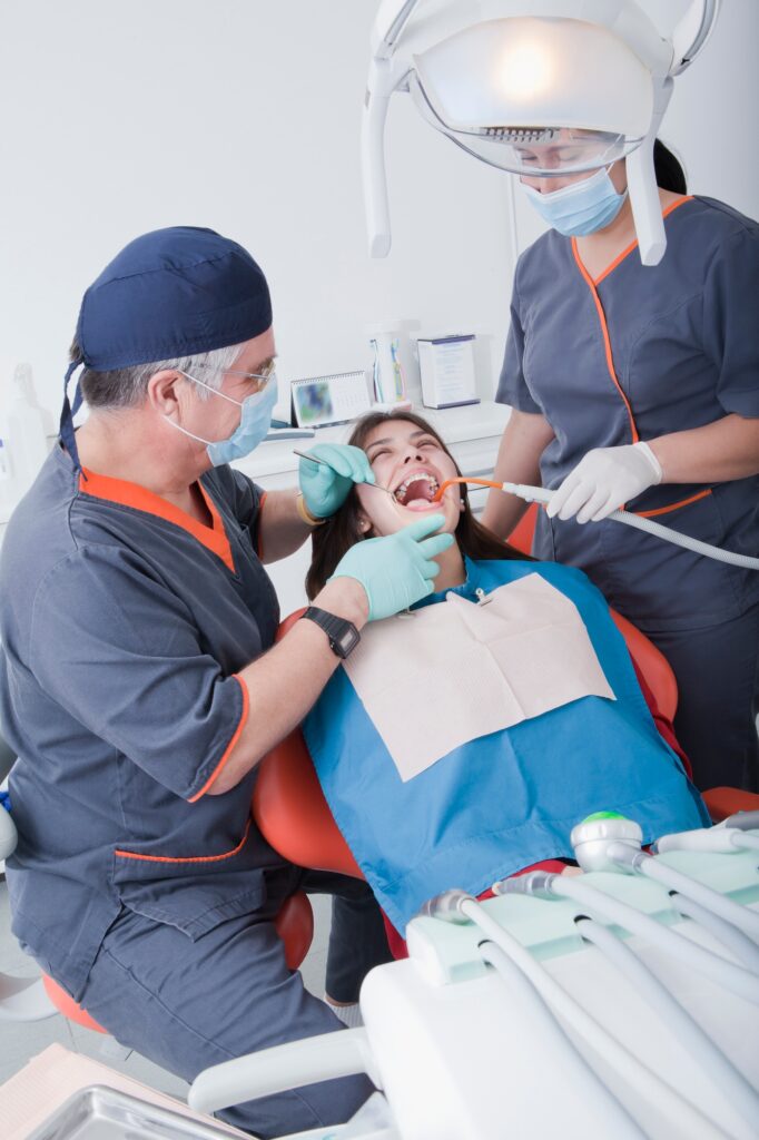Dentist and dental nurse with patient